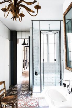 A bohemian Parisian flat boasts tall narrow spaces, but doesn't skimp on style. The classic black and white, with glass and antiques creates a balance in contrasts. Found on domainehome.com