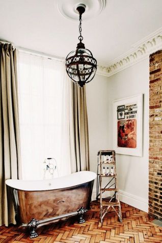 This luxe w/c includes floor to ceiling touches of vintage style, but manages to look thoroughly 'now.' From the crown moulding, heavy drapes, brick and lighting, to the gorgeous tub and old step ladder, this is a perfect marriage of old combined in a new way. Photo: Tour London's Most Lust-Worthy New Boutique Hotel via @Domaine